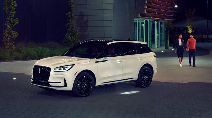 Two people approach a 2024 Lincoln Corsair® SUV featuring the available Jet Appearance Package. | Pugmire Lincoln of Marietta in Marietta GA