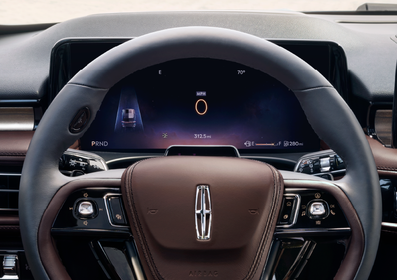 The steering wheel of 2025 Lincoln Aviator® SUV is shown with black and brown accents. | Pugmire Lincoln of Marietta in Marietta GA