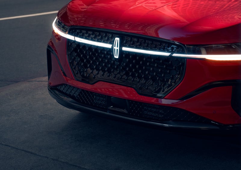 The available front LED light bar and center Lincoln Star logo glow at dusk. | Pugmire Lincoln of Marietta in Marietta GA