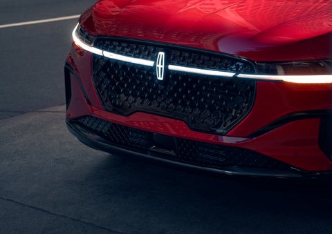 The available front LED light bar and center Lincoln Star logo glow at dusk. | Pugmire Lincoln of Marietta in Marietta GA