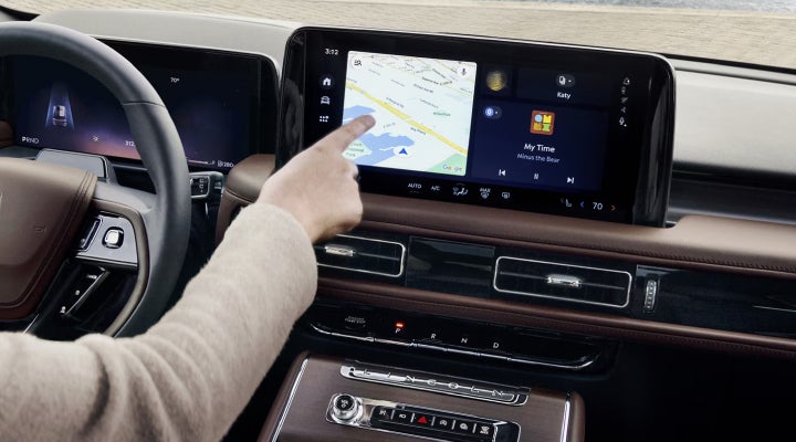 A person is tapping the center display touchscreen of a 2026 Lincoln Aviator® SUV. | Pugmire Lincoln of Marietta in Marietta GA