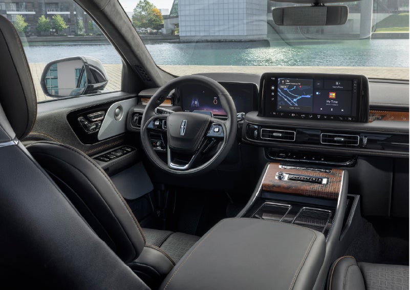 The interior of the 2026 Lincoln Aviator® SUV is shown parked with a view of a harbor through the windshield. | Pugmire Lincoln of Marietta in Marietta GA