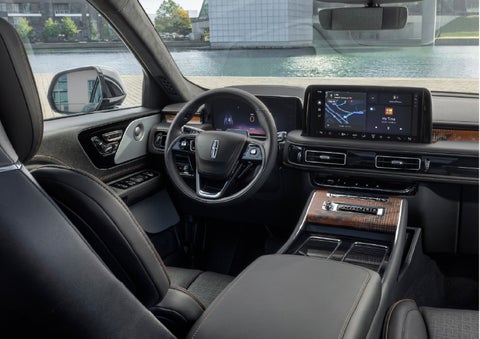 The interior of the 2026 Lincoln Aviator® SUV is shown parked with a view of a harbor through the windshield. | Pugmire Lincoln of Marietta in Marietta GA