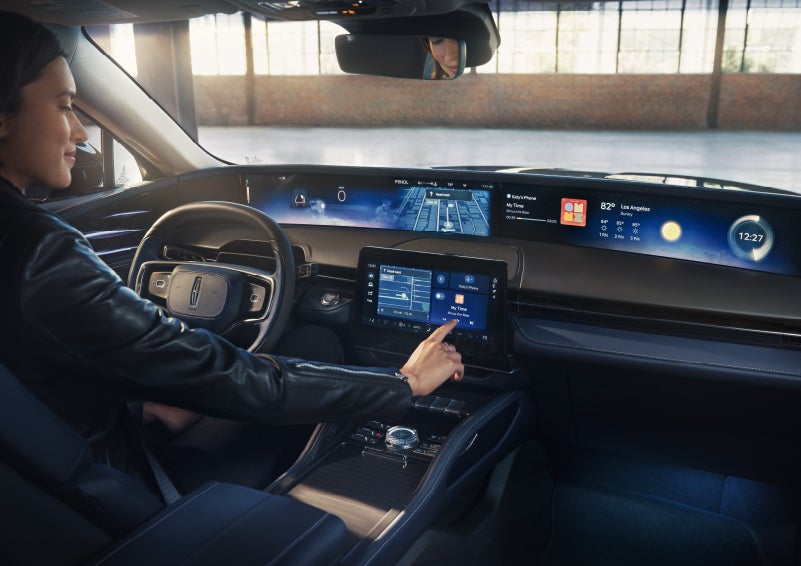 The driver of a 2026 Lincoln Nautilus® SUV interacts with the center touchscreen. | Pugmire Lincoln of Marietta in Marietta GA