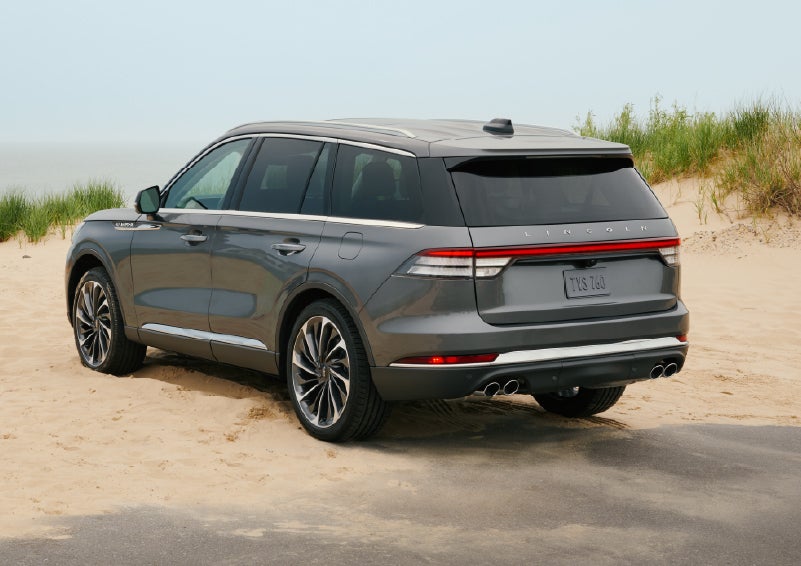 A 2027 Lincoln Aviator® SUV is parked next to sand dunes. | Pugmire Lincoln of Marietta in Marietta GA