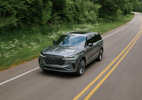 A 2027 Lincoln Aviator® SUV is being driven down a road. | Pugmire Lincoln of Marietta in Marietta GA