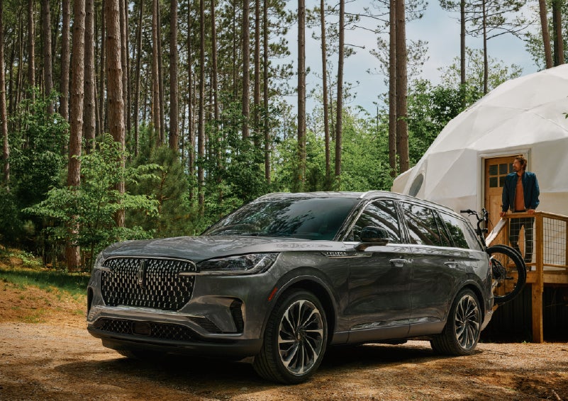 A 2027 Lincoln Aviator® is parked next to a high end glamping site. | Pugmire Lincoln of Marietta in Marietta GA