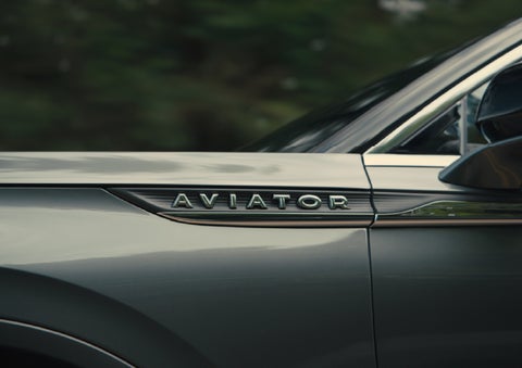 The driver’s side door and fender badging of a gray 2027 Lincoln Aviator® SUV are showcased. | Pugmire Lincoln of Marietta in Marietta GA
