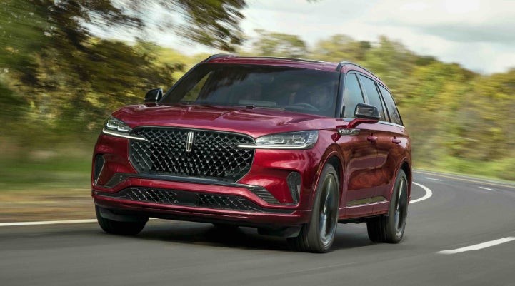 A 2027 Lincoln Aviator® SUV is being driven on a country road | Pugmire Lincoln of Marietta in Marietta GA