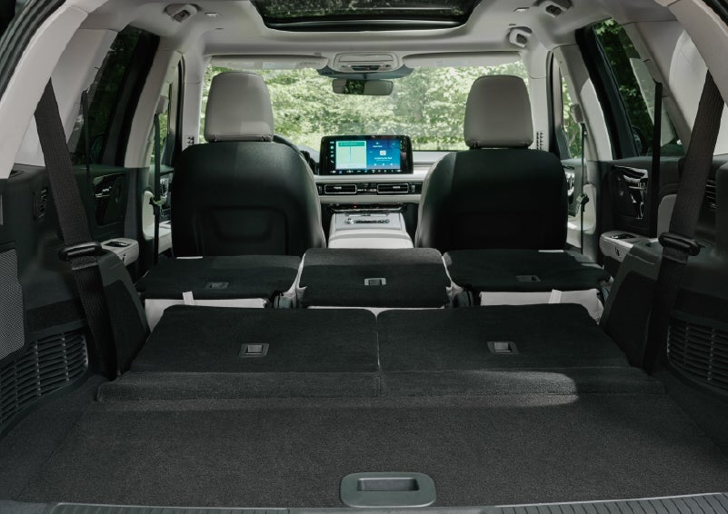 A rear to front view of the interior of a 2027 Lincoln Aviator® Black Label™ SUV shows the third and second rows folded flat | Pugmire Lincoln of Marietta in Marietta GA