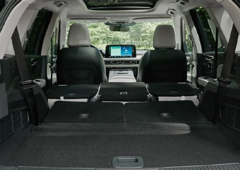 A rear to front view of the interior of a 2027 Lincoln Aviator® Black Label™ SUV shows the third and second rows folded flat | Pugmire Lincoln of Marietta in Marietta GA